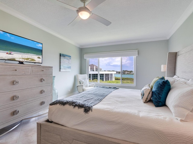 bedroom featuring a textured ceiling, ceiling fan, and ornamental molding