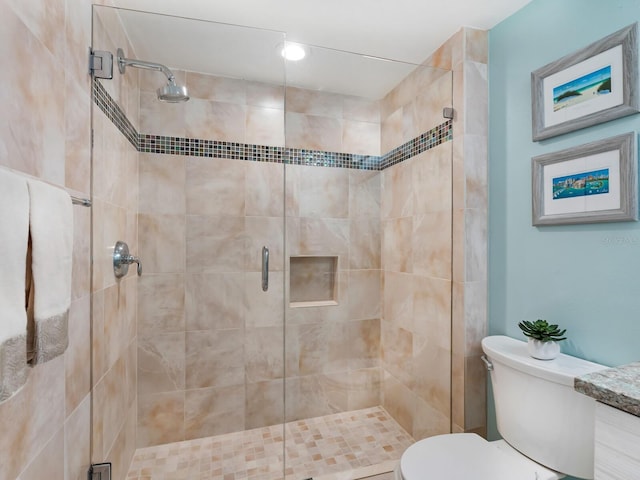 bathroom featuring toilet and walk in shower