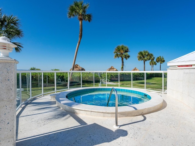 view of swimming pool featuring an in ground hot tub