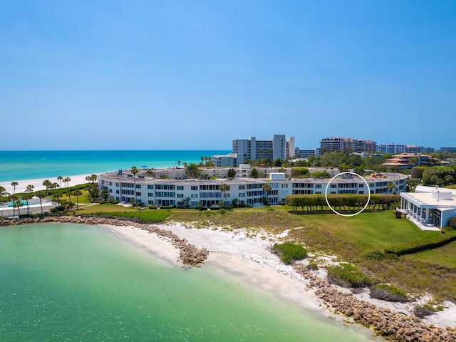 bird's eye view with a water view and a view of the beach