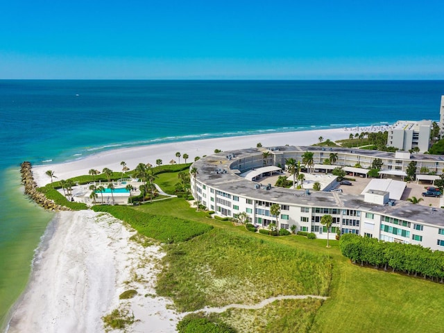 birds eye view of property featuring a beach view and a water view