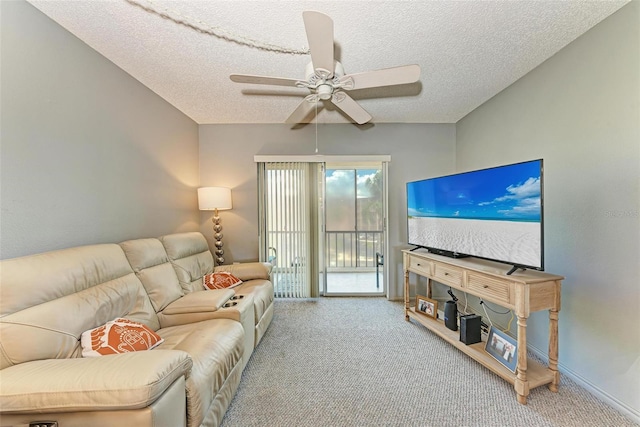 living room featuring ceiling fan, carpet, and a textured ceiling