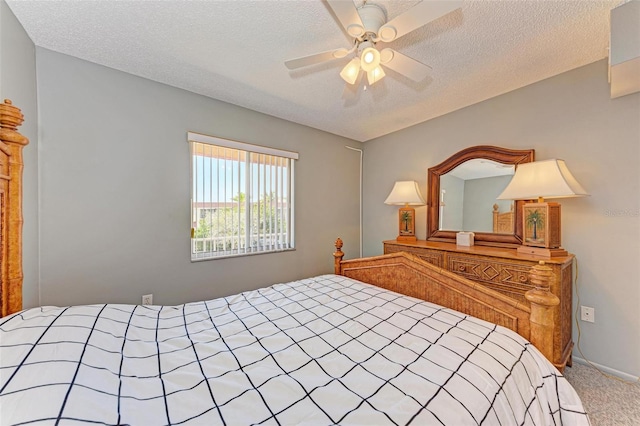 carpeted bedroom featuring a textured ceiling and ceiling fan