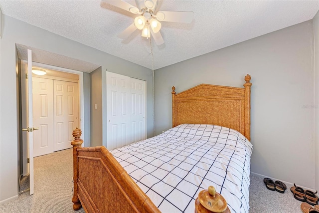 carpeted bedroom featuring a closet, ceiling fan, and a textured ceiling