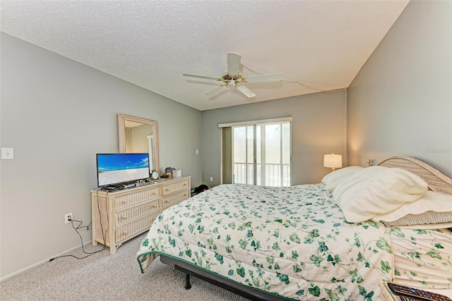 bedroom with a textured ceiling, ceiling fan, carpet, and vaulted ceiling