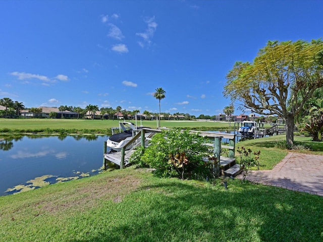 dock area with a yard and a water view