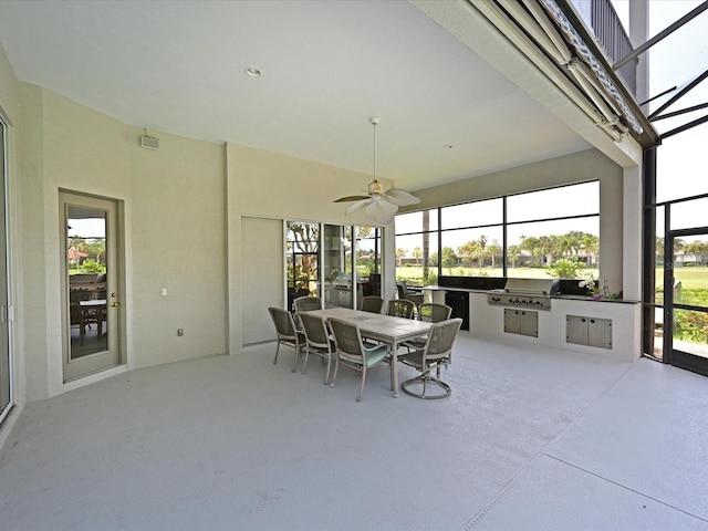 sunroom / solarium with ceiling fan and a healthy amount of sunlight