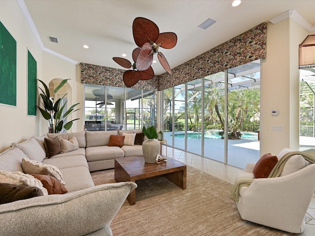 tiled living room featuring ceiling fan and ornamental molding