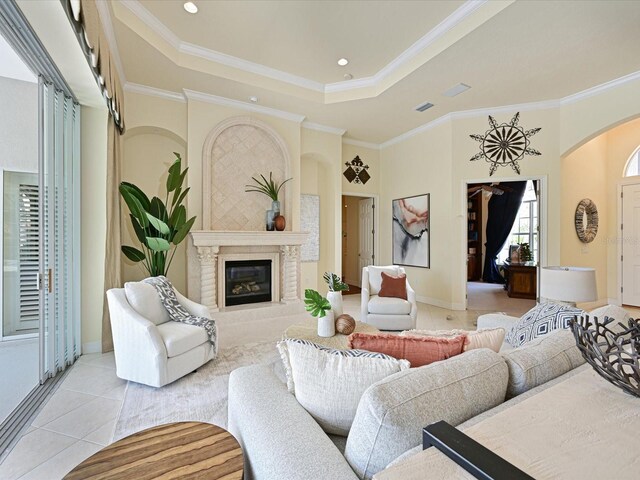 tiled living room with a raised ceiling and ornamental molding