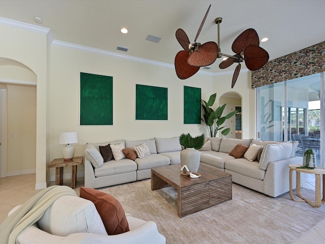 tiled living room featuring ceiling fan and crown molding