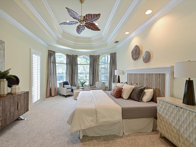 bedroom featuring light colored carpet, ceiling fan, a tray ceiling, and ornamental molding