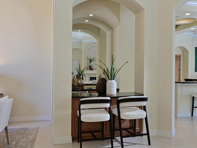 dining room featuring light tile patterned flooring and crown molding