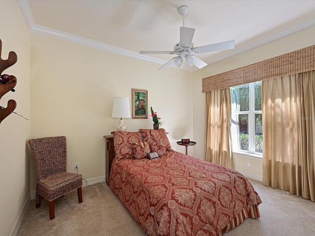 bedroom featuring ornamental molding, light colored carpet, and ceiling fan