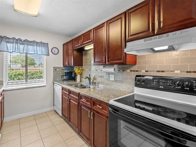 kitchen with white appliances, light tile floors, sink, tasteful backsplash, and a textured ceiling