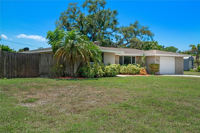 single story home featuring a garage and a front lawn