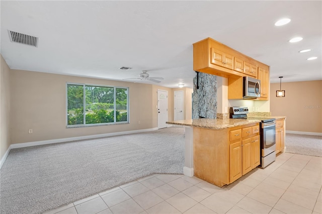 kitchen with light colored carpet, ceiling fan, stainless steel appliances, and light stone countertops