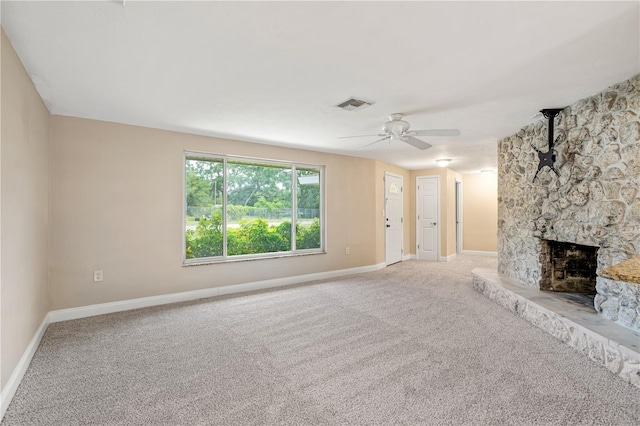 unfurnished living room featuring carpet, ceiling fan, and a fireplace