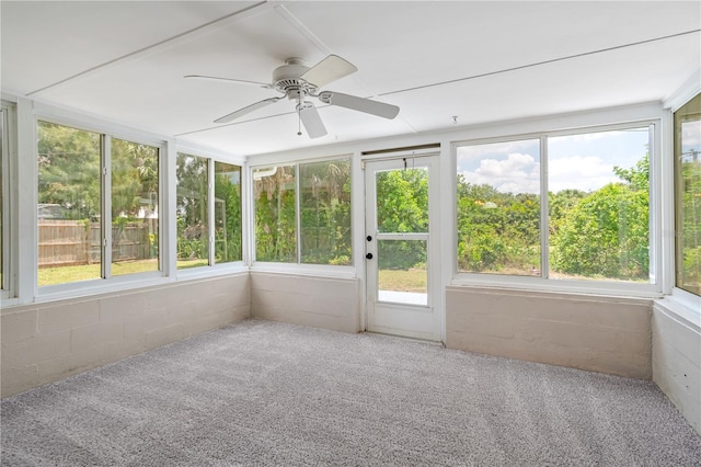 unfurnished sunroom with ceiling fan