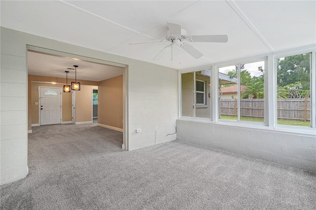 carpeted spare room featuring ceiling fan