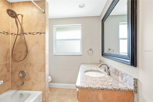 full bathroom featuring tiled shower / bath, toilet, tile flooring, and vanity