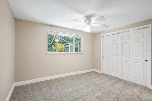 unfurnished bedroom featuring a closet, ceiling fan, and carpet floors