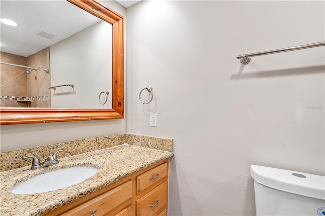 bathroom with vanity with extensive cabinet space and toilet