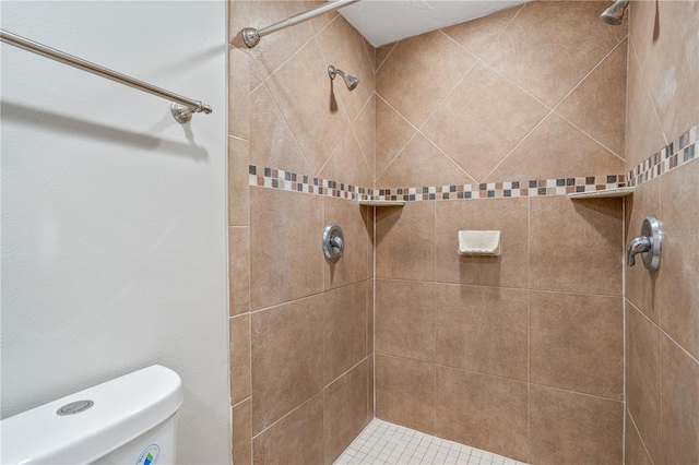 bathroom with tiled shower and toilet