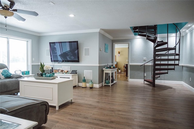 living room featuring wood-type flooring, a textured ceiling, ceiling fan, and crown molding