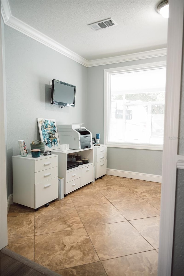 tiled home office with ornamental molding and a textured ceiling