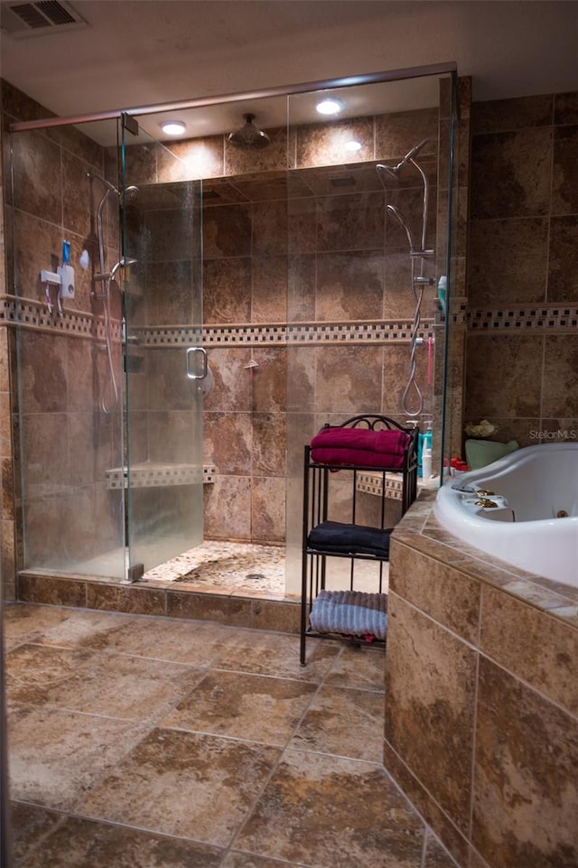 bathroom with independent shower and bath, tile walls, and tile floors