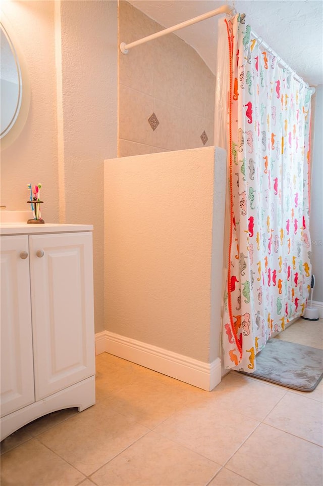 bathroom featuring tile flooring and vanity