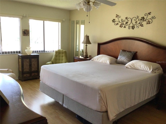 bedroom featuring wood-type flooring and ceiling fan