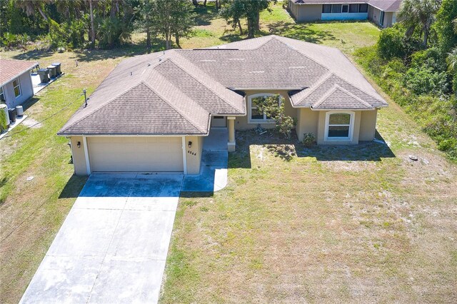 view of front facade with a garage and a front lawn