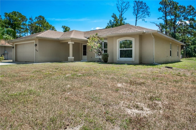 ranch-style home featuring a garage and a front lawn