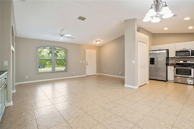 kitchen featuring white cabinetry, hanging light fixtures, ceiling fan with notable chandelier, appliances with stainless steel finishes, and light tile patterned floors