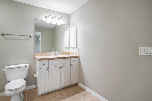 bathroom featuring vanity, toilet, and tile patterned floors