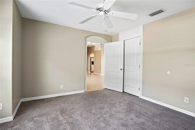 interior space featuring carpet floors, ceiling fan, and a closet