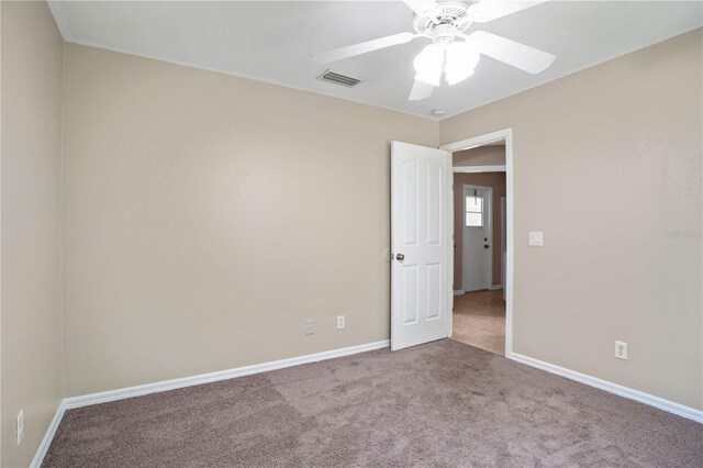 spare room with light carpet and ceiling fan