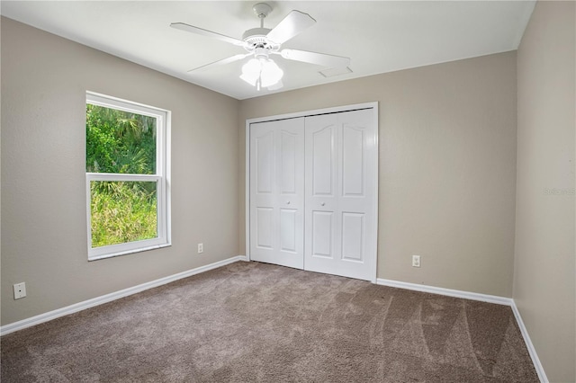 unfurnished bedroom with a closet, carpet floors, and ceiling fan