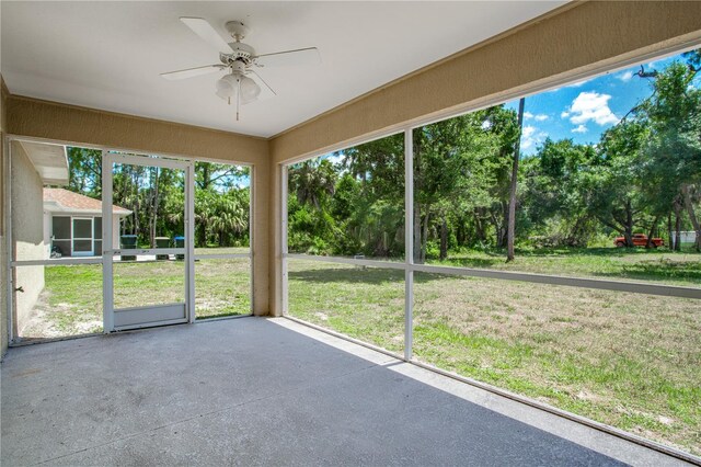 unfurnished sunroom featuring ceiling fan