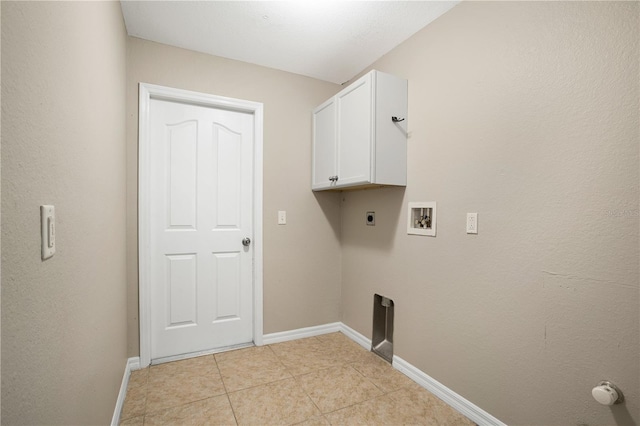 laundry area featuring cabinets, electric dryer hookup, washer hookup, and light tile patterned floors