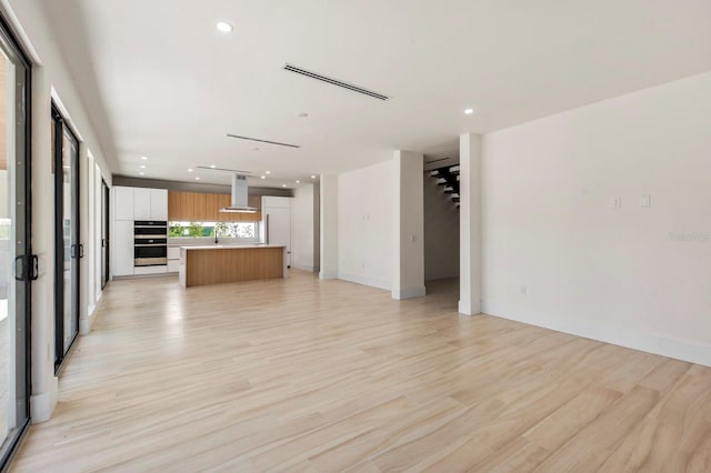 unfurnished living room with light wood-type flooring