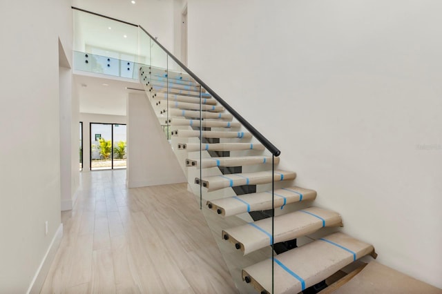 staircase featuring a high ceiling