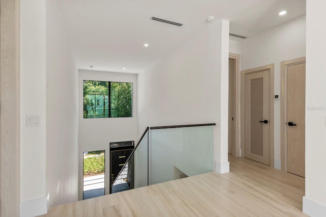 hallway with plenty of natural light and light wood-type flooring