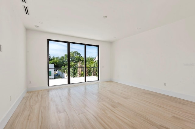 empty room with light hardwood / wood-style flooring