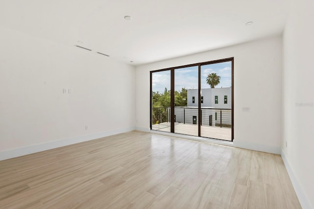 spare room with light wood-type flooring