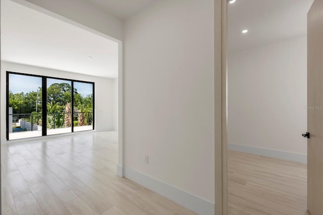 empty room with light hardwood / wood-style flooring