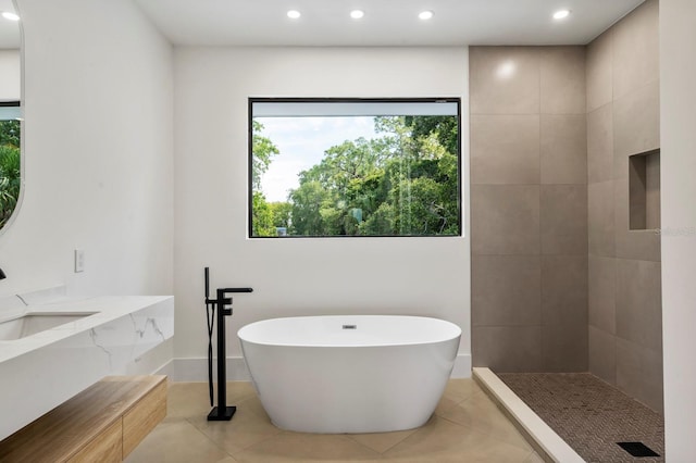 bathroom featuring sink, tile floors, and shower with separate bathtub