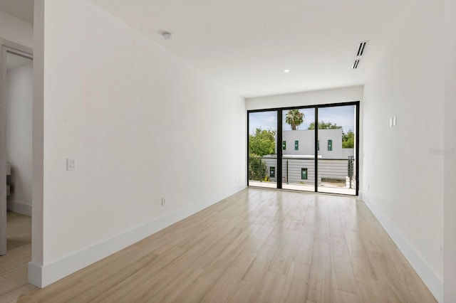 spare room with light hardwood / wood-style floors