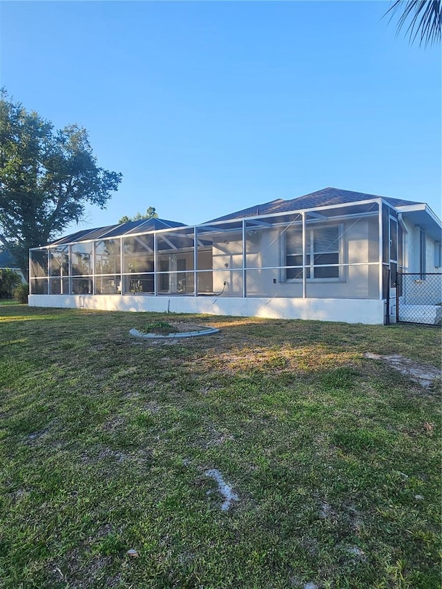 rear view of property featuring a yard